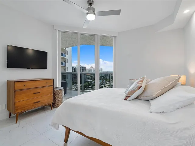 a bedroom with a bed and flat screen tv