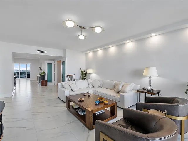 a living room with furniture and a lamp