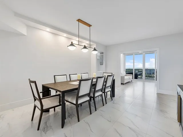 a dining room with furniture and window