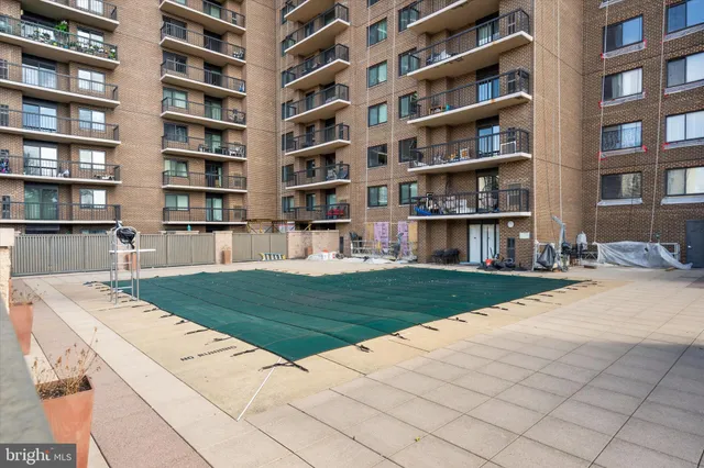 a living room with furniture and a book shelf