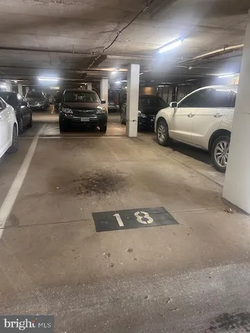 a view of parking garage with cars parked