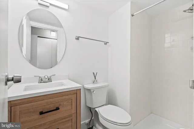 a bathroom with a sink toilet and mirror
