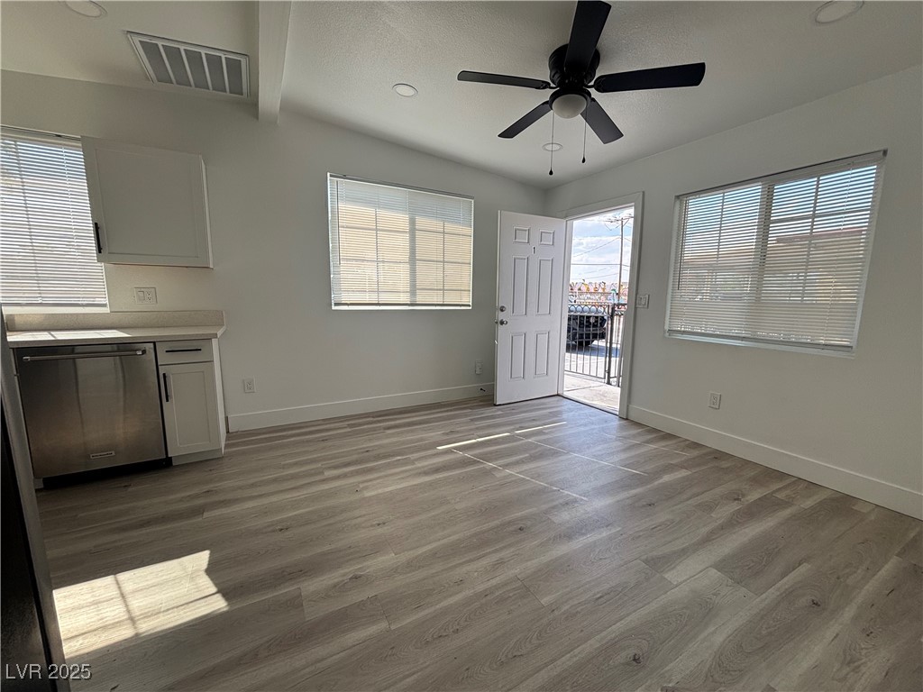 724 North 9th Street, Unit 1 Las Vegas, NV 89101 - Photo 1 of 8 Unfurnished dining area featuring light wood finished floors, a ceiling fan, recessed lighting, and beam ceiling