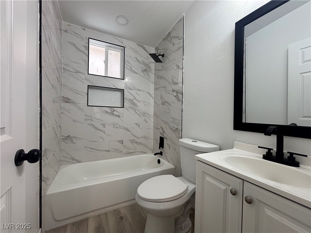 724 North 9th Street, Unit 1 Las Vegas, NV 89101 - Photo 3 of 8 Bathroom with light wood finished floors, vanity, and tub / shower combination