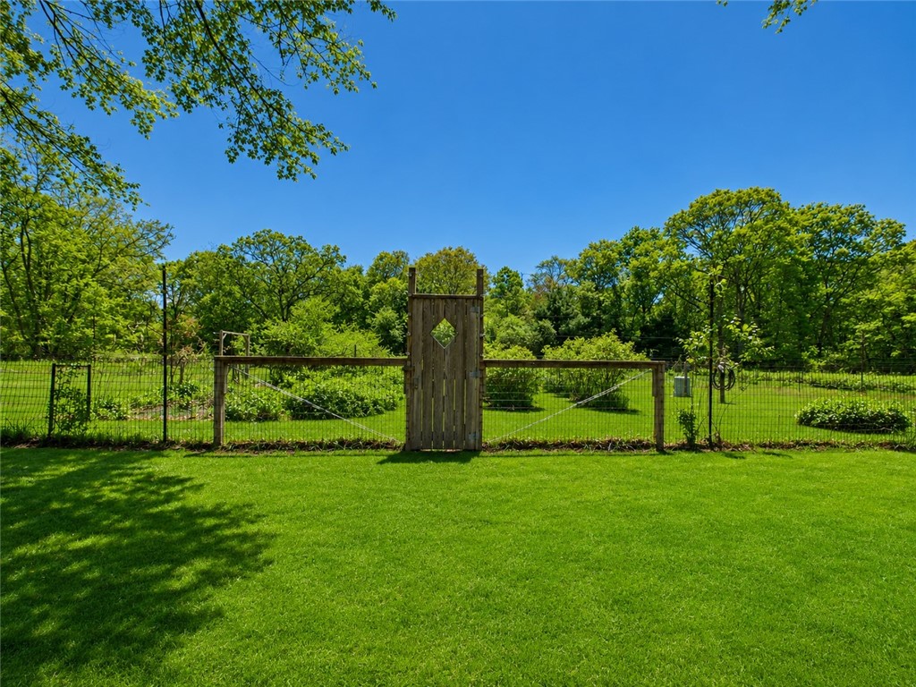 307 Stony Fort Road Saunderstown, RI 02874 - Photo 15 of 48 The garden door leading to 100 x 100 fenced vegetable garden with established asparagus bed