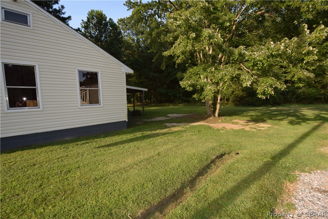 561 Possum Point Road Port Haywood, VA 23138 - Photo 22 of 23 a view of a backyard with large trees