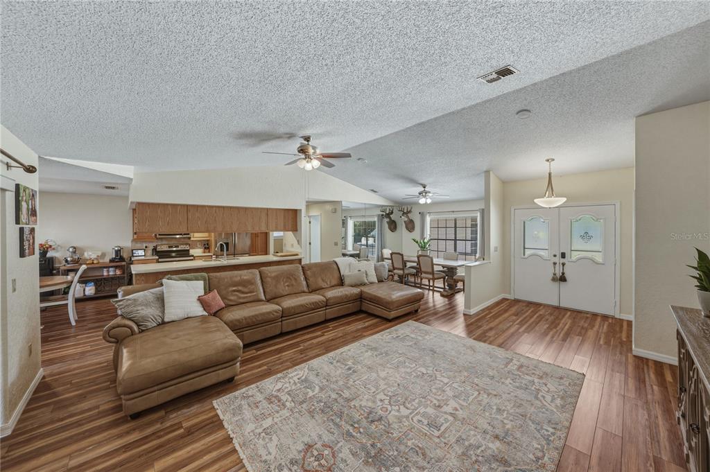 7435 Kilbride Court Weeki Wachee, FL 34613 - Photo 6 of 67 a living room with furniture and wooden floor