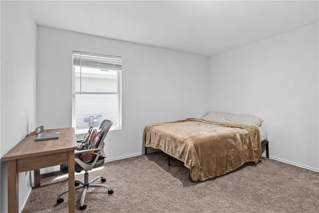 a bedroom with a bed and a desk