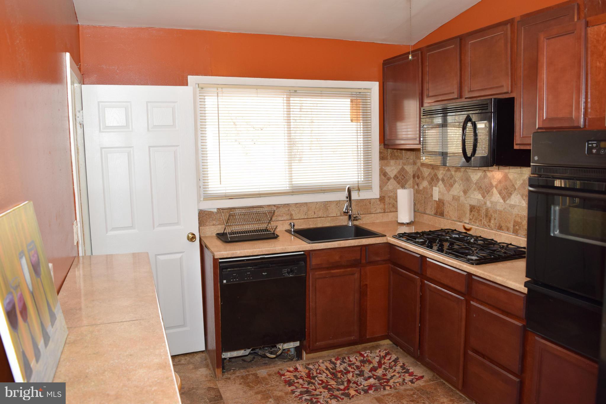 4775 Byron Road Baltimore, MD 21244 - Photo 5 of 29 a kitchen with a sink stove and refrigerator