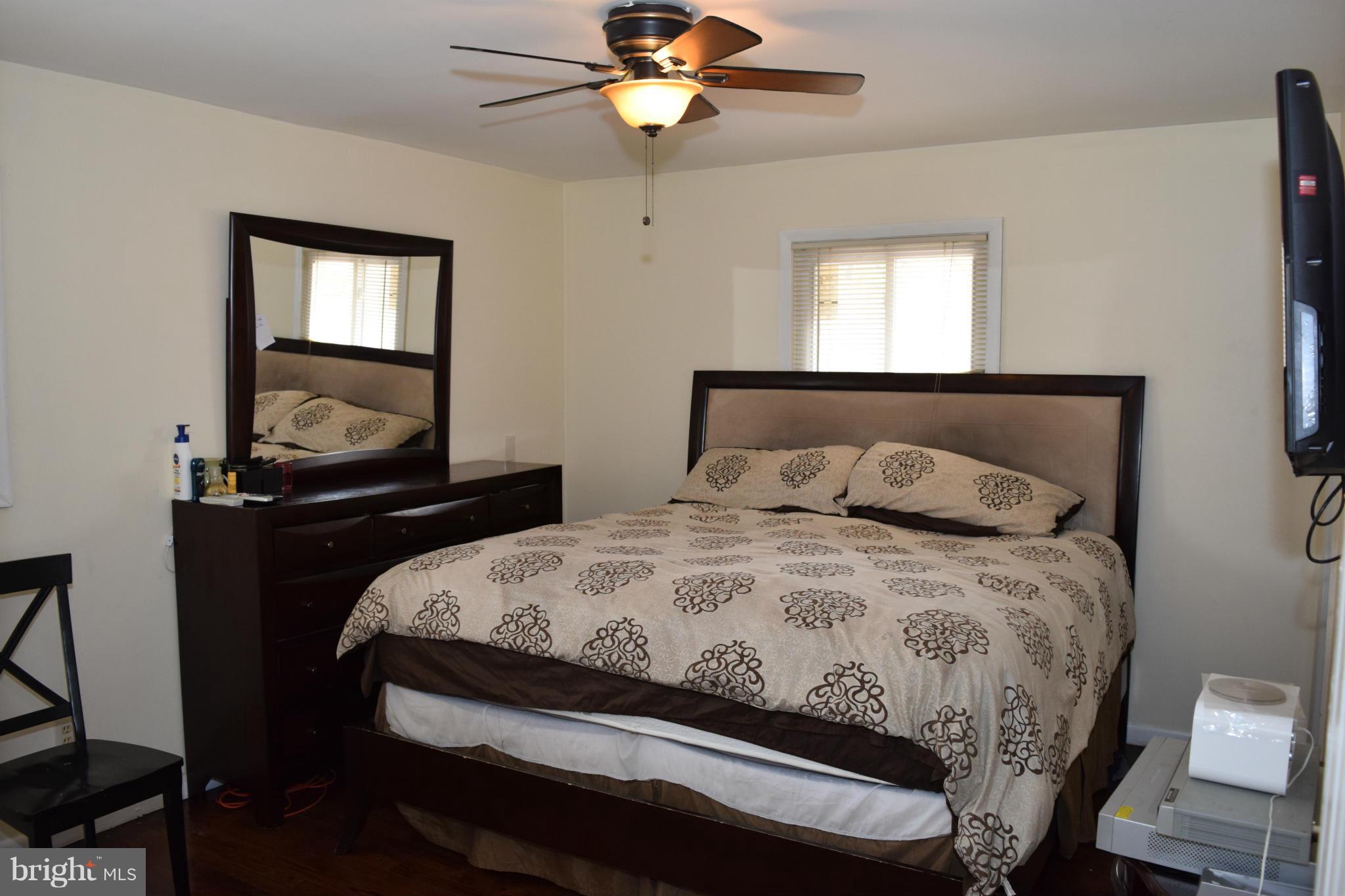 4775 Byron Road Baltimore, MD 21244 - Photo 8 of 29 a bedroom with a bed and a chandelier