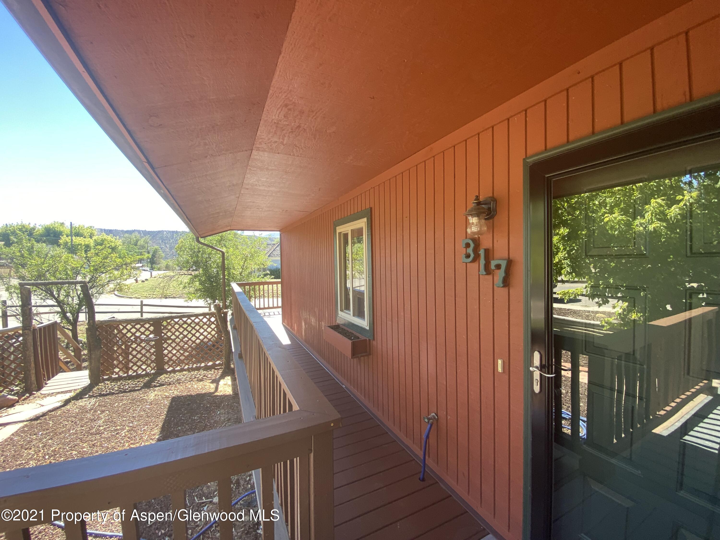 317 Clarkson Avenue Rifle, CO 81650 - Photo 3 of 17 a view of balcony with floor to ceiling window wooden floor and outdoor space