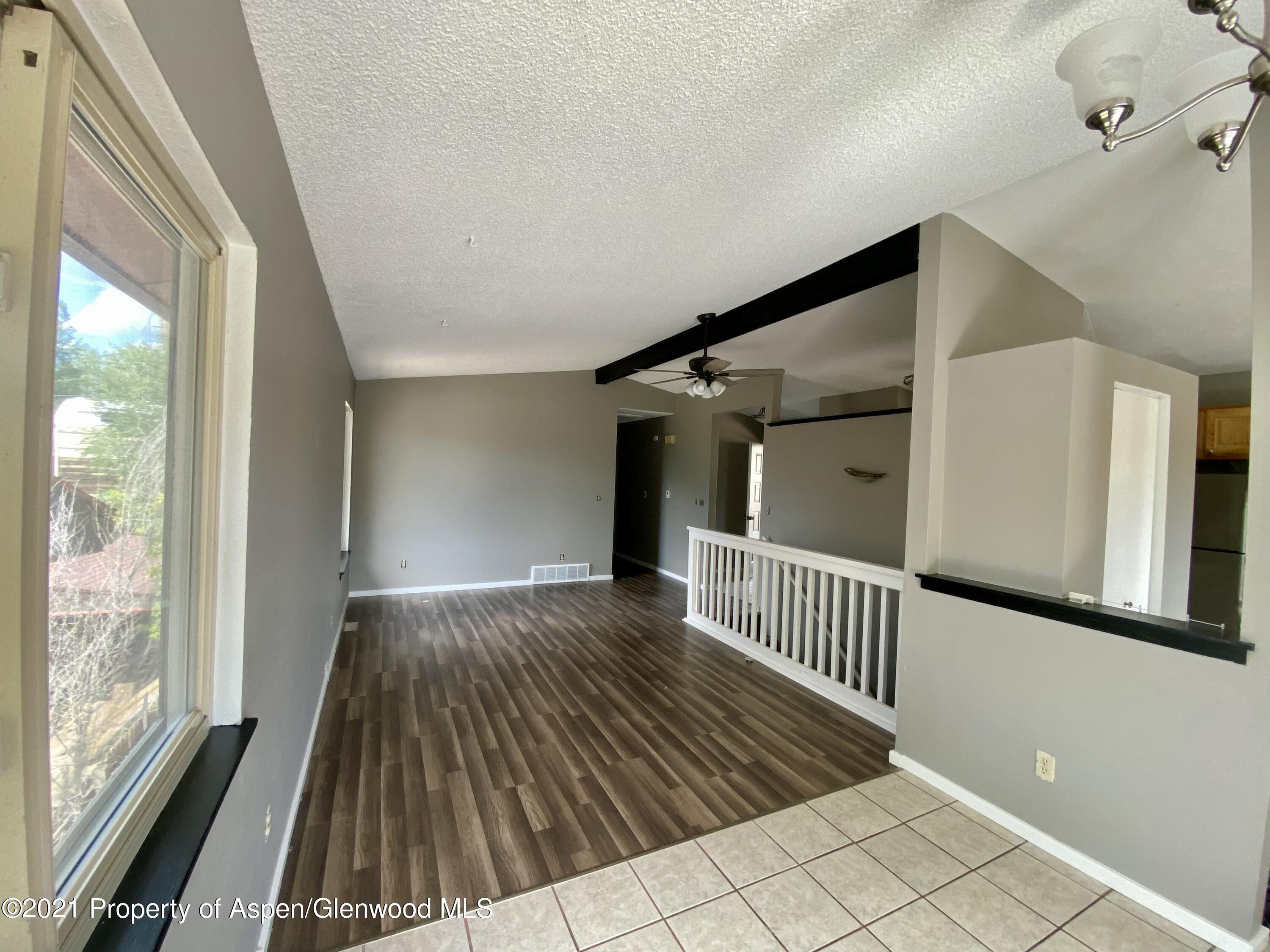 317 Clarkson Avenue Rifle, CO 81650 - Photo 4 of 17 a view of a hallway with wooden floor and staircase