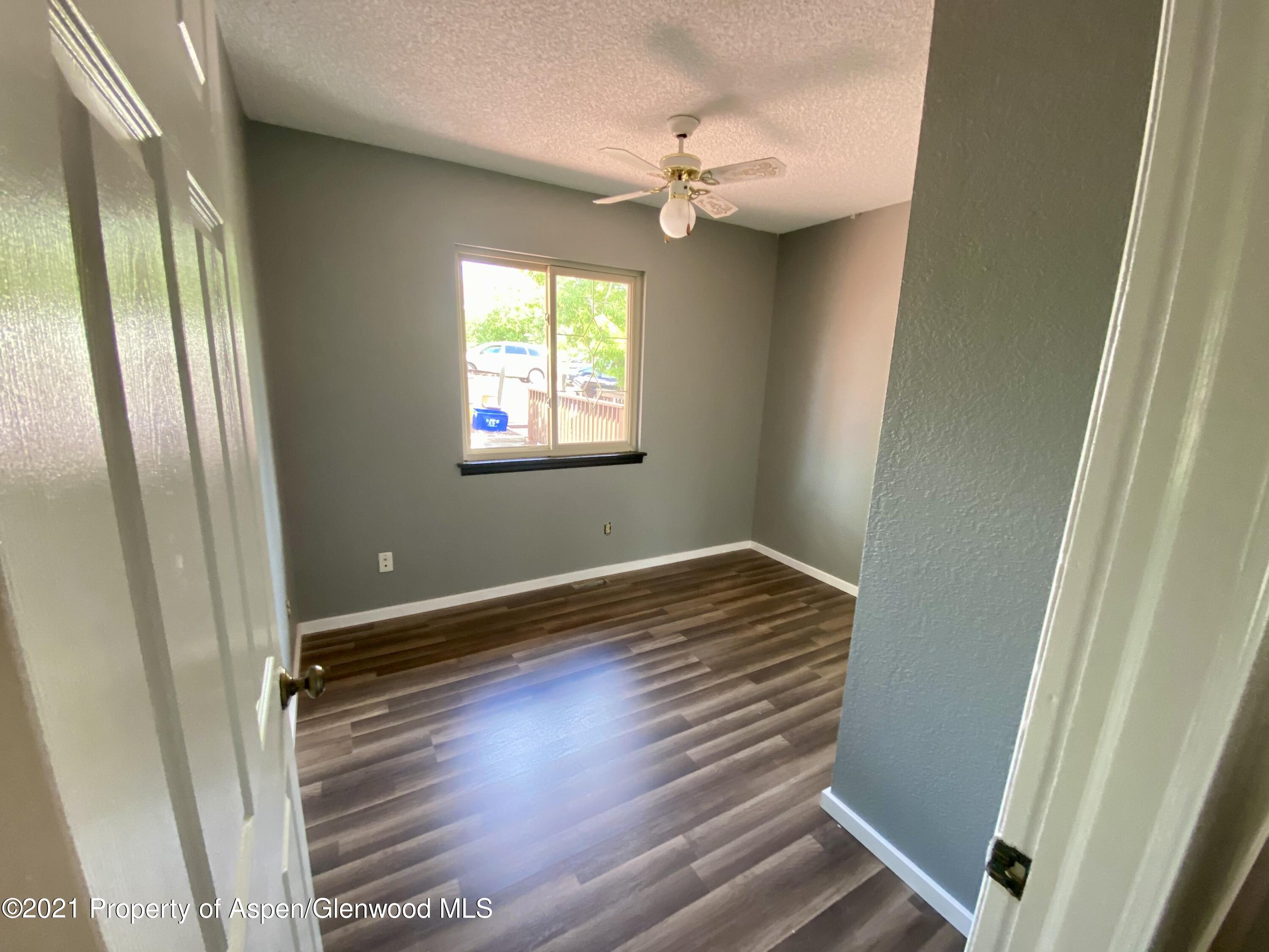 317 Clarkson Avenue Rifle, CO 81650 - Photo 7 of 17 a view of room with window and hardwood floor