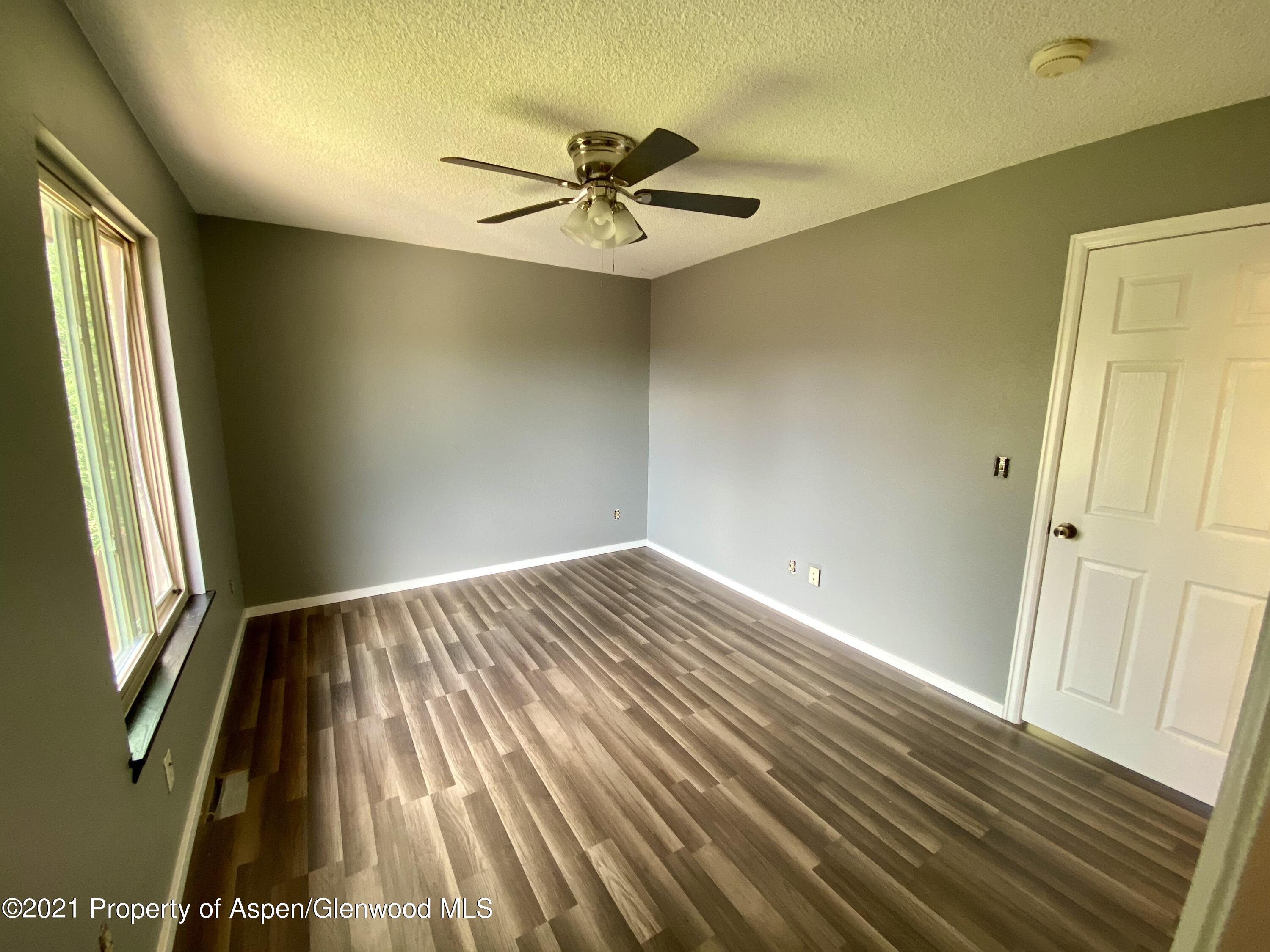 317 Clarkson Avenue Rifle, CO 81650 - Photo 8 of 17 a view of an empty room and wooden floor