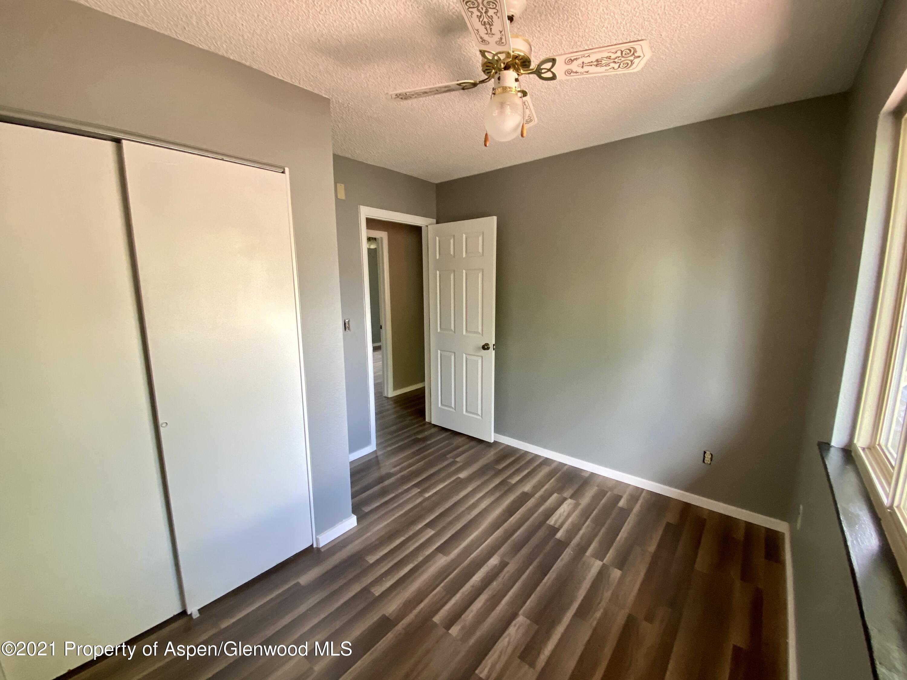 317 Clarkson Avenue Rifle, CO 81650 - Photo 10 of 17 a view of room with window and hardwood floor