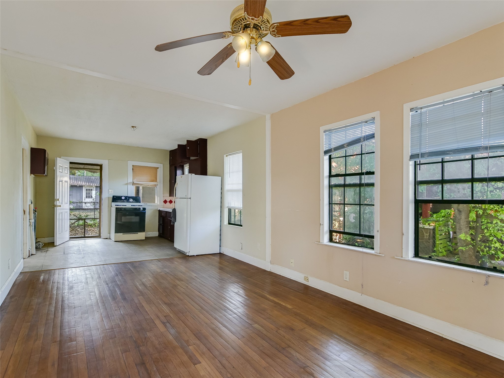 66 Cross Street Austin, TX 78702 - Photo 11 of 20 a view of a livingroom with wooden floor a ceiling fan and windows