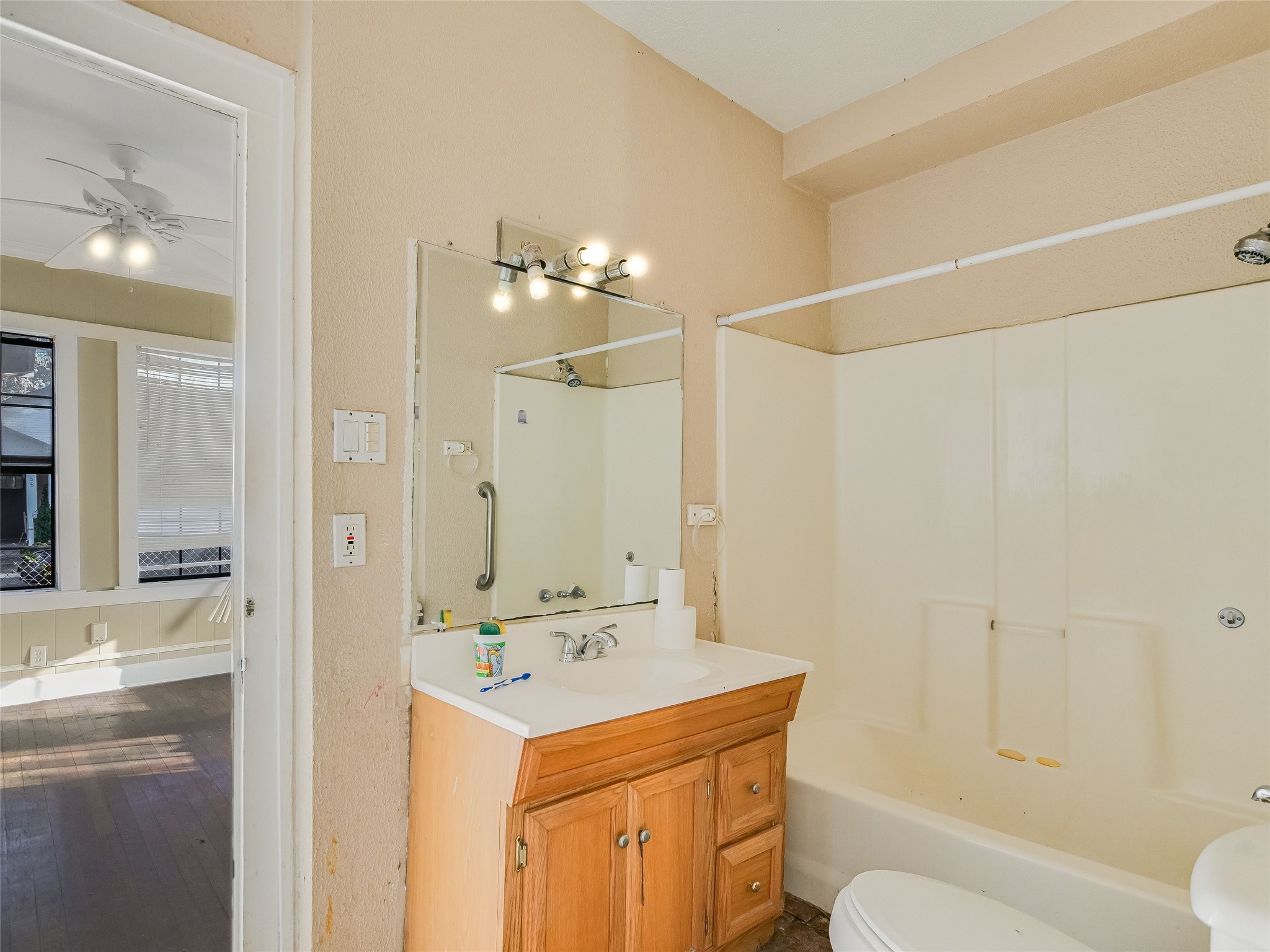 66 Cross Street Austin, TX 78702 - Photo 5 of 20 a bathroom with a sink a toilet a mirror and shower