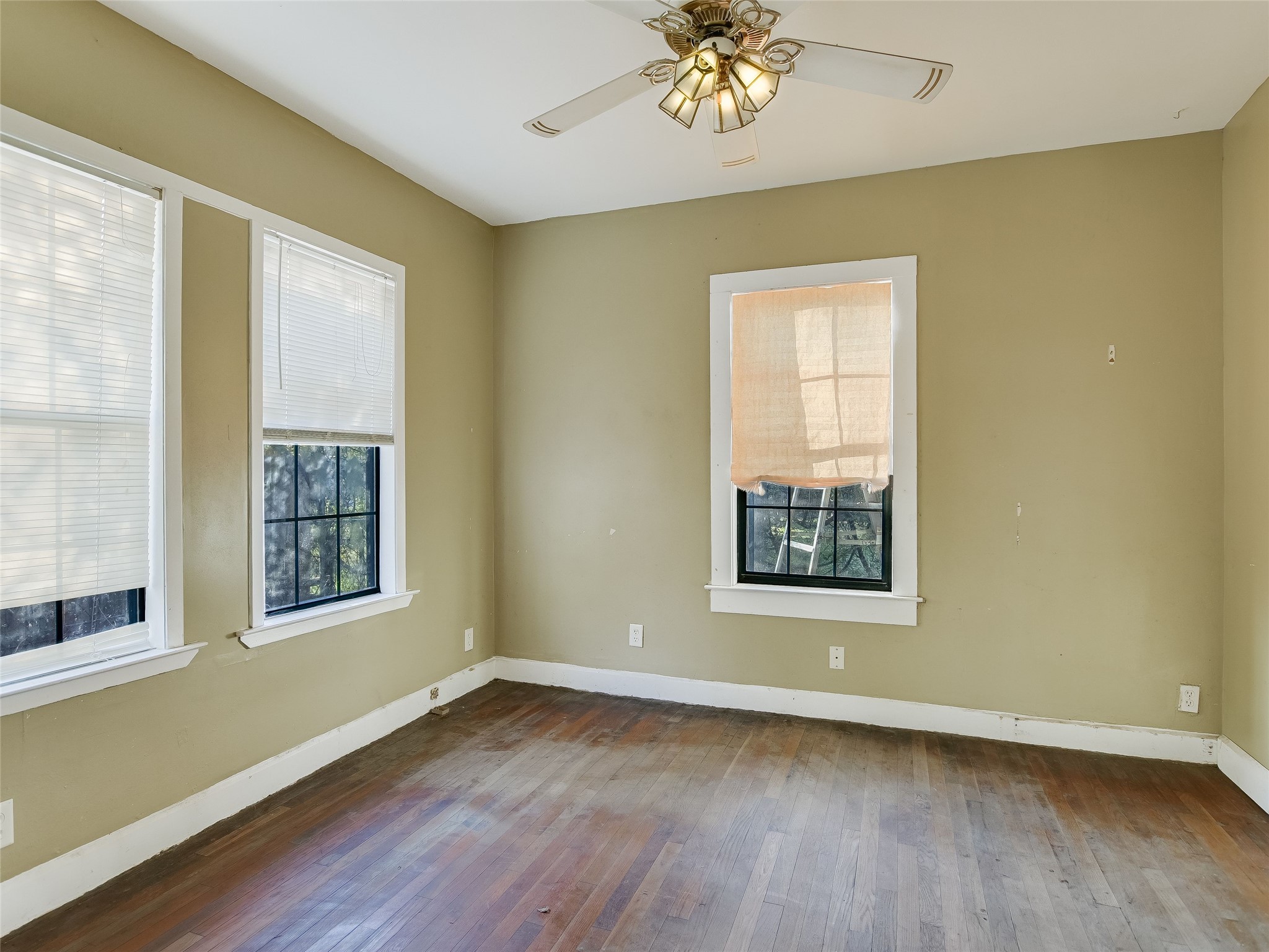 66 Cross Street Austin, TX 78702 - Photo 6 of 20 a view of an empty room with a window and wooden floor