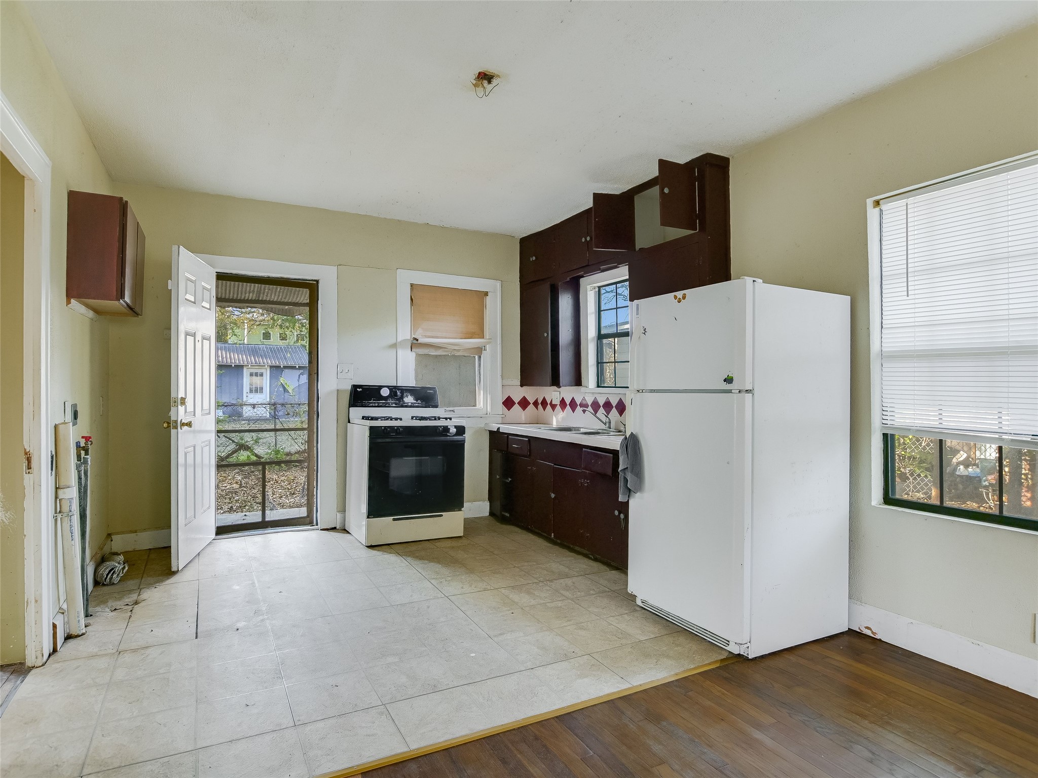 66 Cross Street Austin, TX 78702 - Photo 9 of 20 a kitchen with stainless steel appliances a refrigerator sink and cabinets
