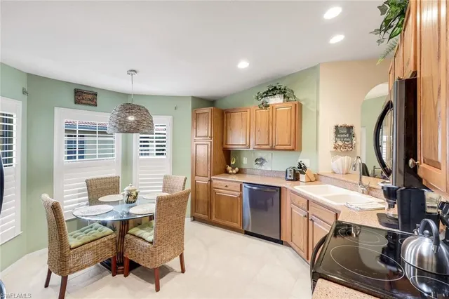 a kitchen with a table chairs sink and cabinets