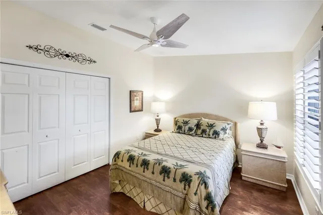 a bedroom with a bed and a ceiling fan
