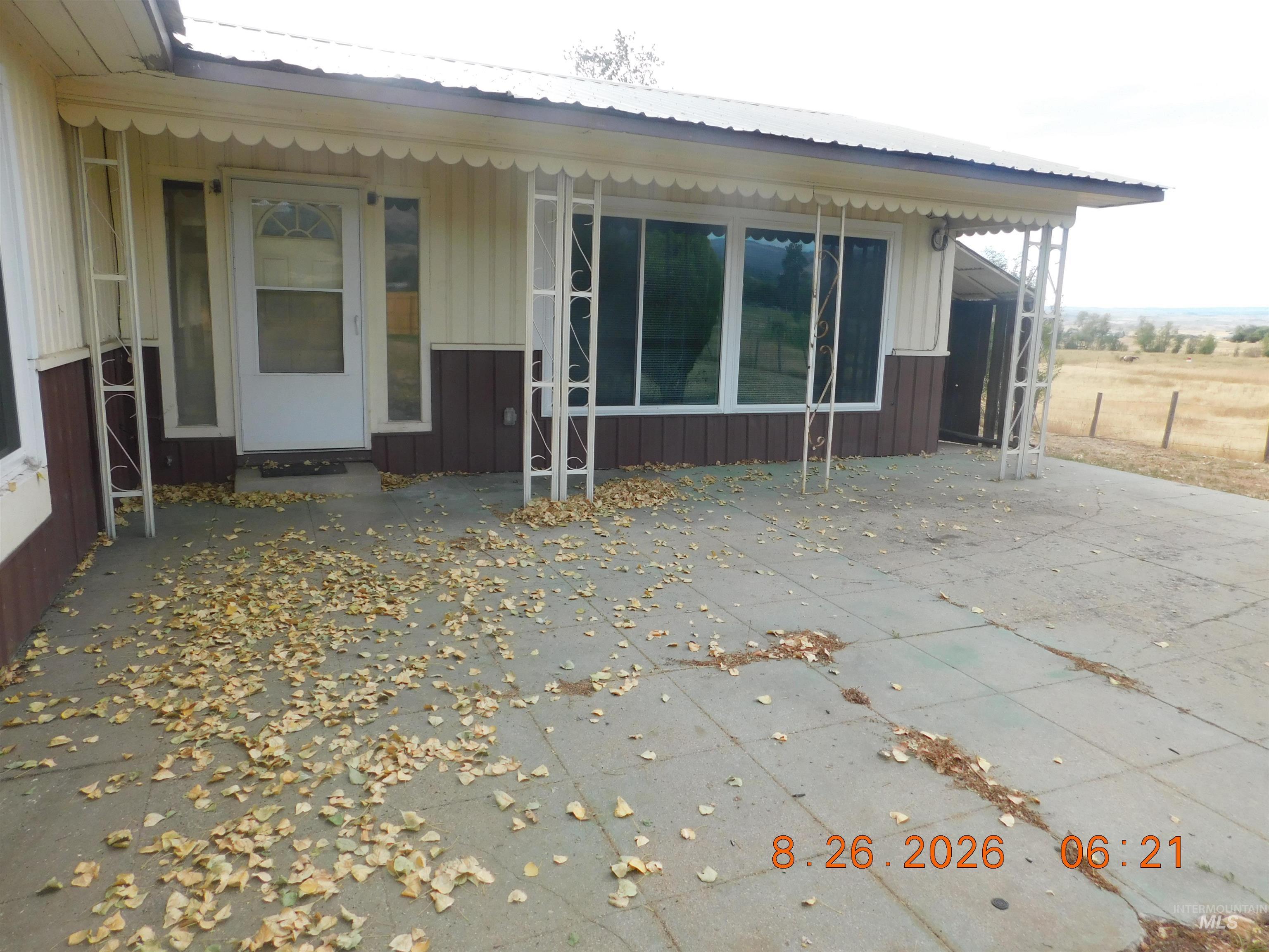 2115 North Galena Road Council, ID 83612 - Photo 4 of 18 Covered porch with decorative white trim, multiple windows, and a glass-paneled entry door