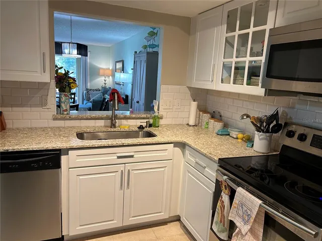 a kitchen with a sink stove and cabinets