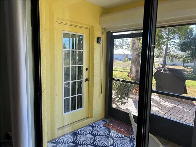 a living room with a fireplace and large windows