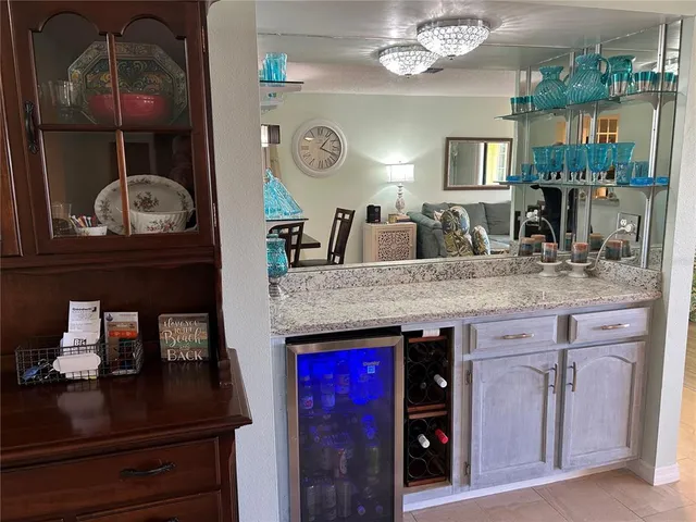 a kitchen with stove and wooden floor
