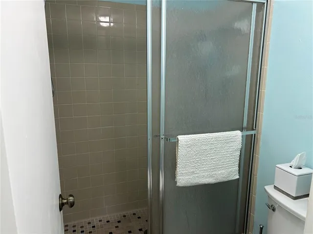 a bathroom with a shower and a sink