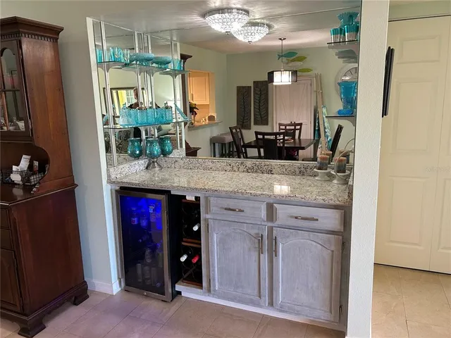 a view of a bathroom with a granite countertop sink and a mirror