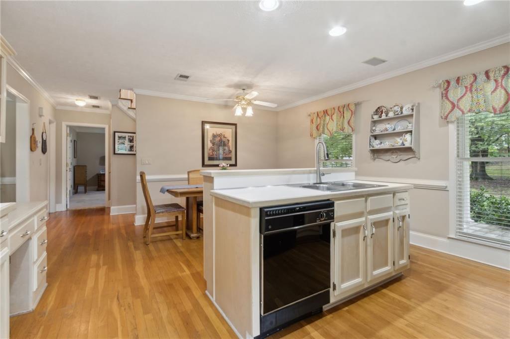 83 Russell Road Lawrenceville, GA 30043 - Photo 14 of 67 a kitchen with stainless steel appliances granite countertop a stove and a wooden floors