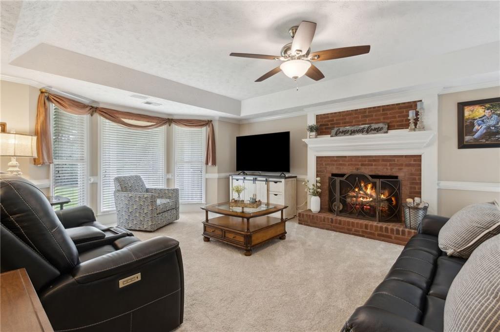 83 Russell Road Lawrenceville, GA 30043 - Photo 18 of 67 a living room with furniture a fireplace and a flat screen tv