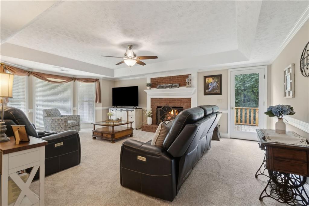 83 Russell Road Lawrenceville, GA 30043 - Photo 19 of 67 a living room with furniture ceiling fan and a flat screen tv