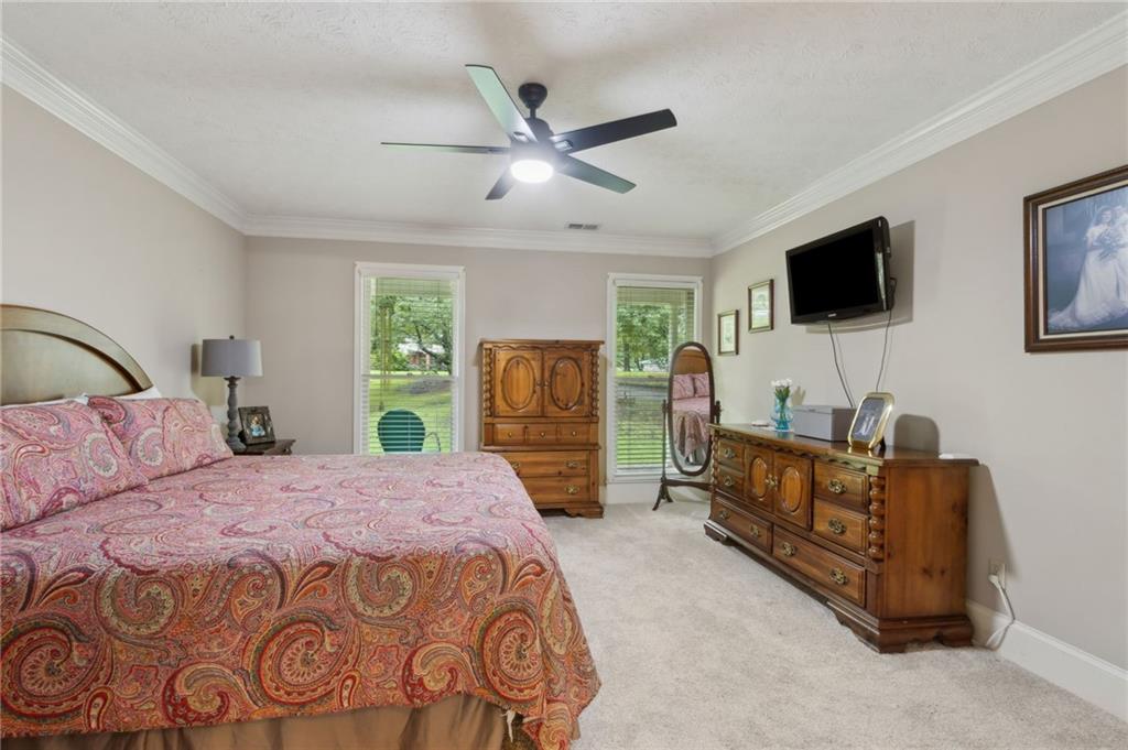 83 Russell Road Lawrenceville, GA 30043 - Photo 26 of 67 a bedroom with a bed and a flat screen tv