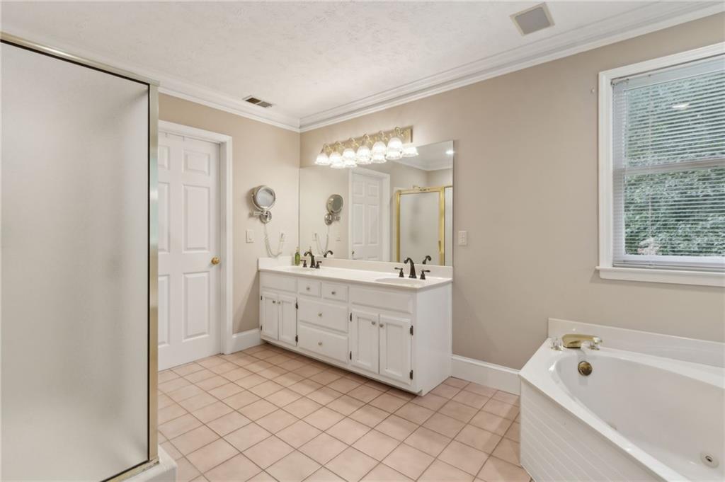 83 Russell Road Lawrenceville, GA 30043 - Photo 30 of 67 a spacious bathroom with a double vanity sink mirror and bathtub