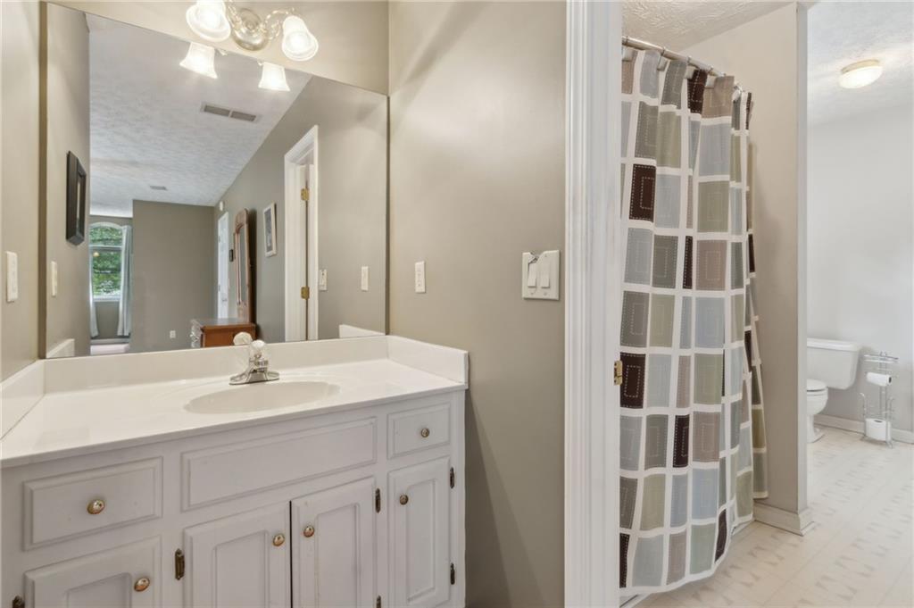 83 Russell Road Lawrenceville, GA 30043 - Photo 40 of 67 a bathroom with a sink a vanity and a mirror