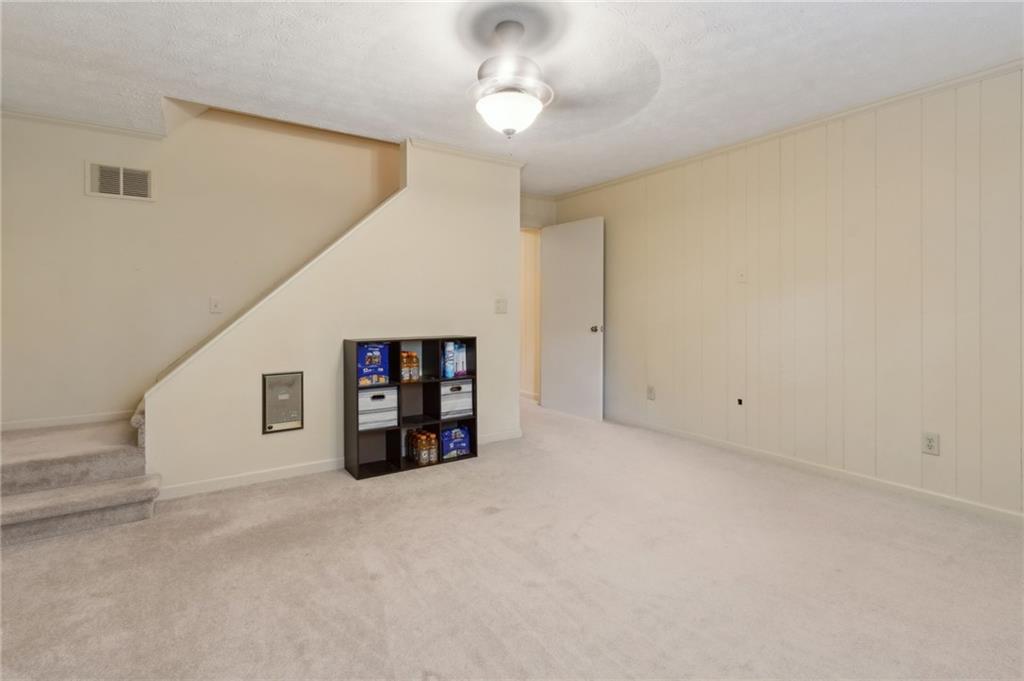 83 Russell Road Lawrenceville, GA 30043 - Photo 45 of 67 a view of an empty room with a ceiling fan and window