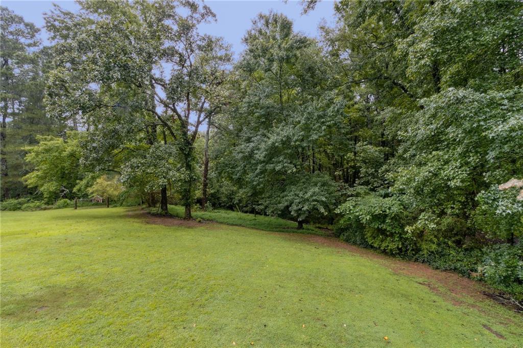 83 Russell Road Lawrenceville, GA 30043 - Photo 56 of 67 a view of a field with a tree