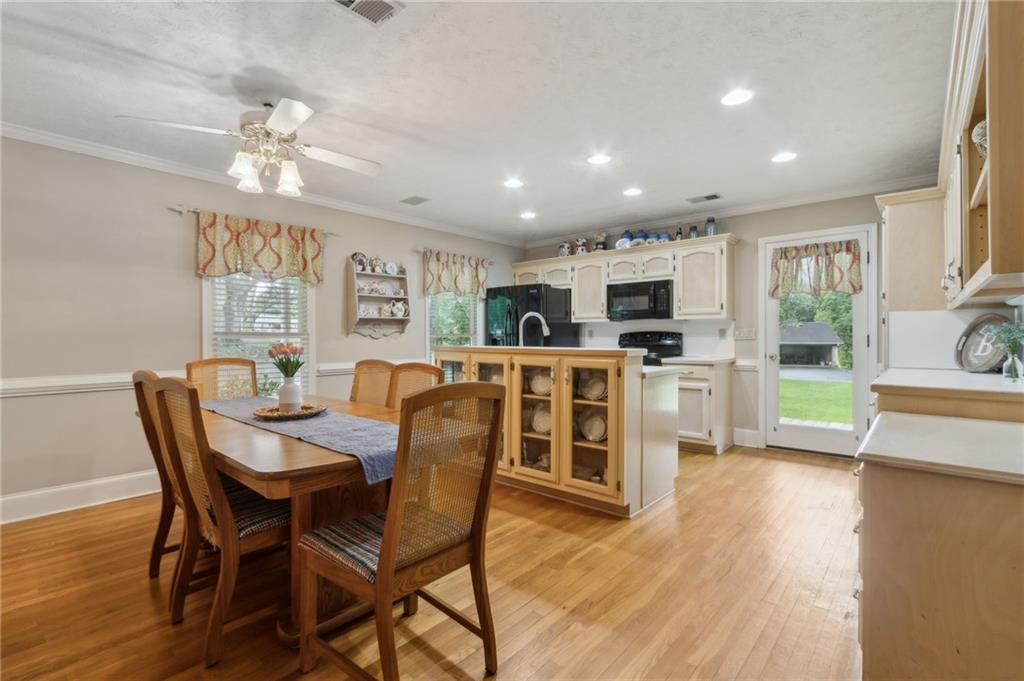 83 Russell Road Lawrenceville, GA 30043 - Photo 9 of 67 a view of a dining room with furniture and wooden floor