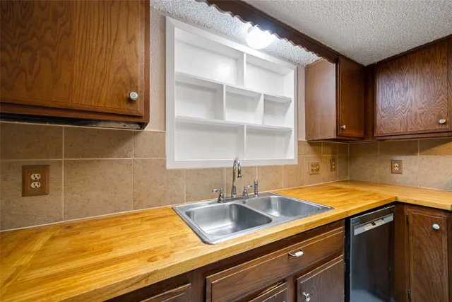 a kitchen with a sink and cabinets