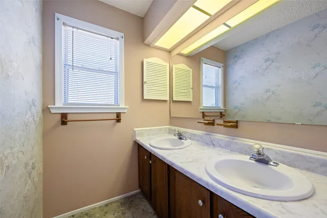 a bathroom with a sink and a mirror
