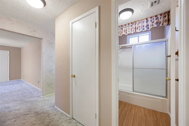 a hallway with windows and a wooden door