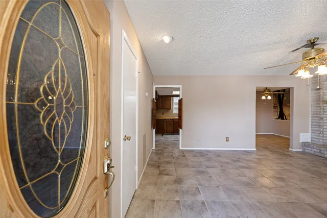 an entryway with wooden floor and cabinet