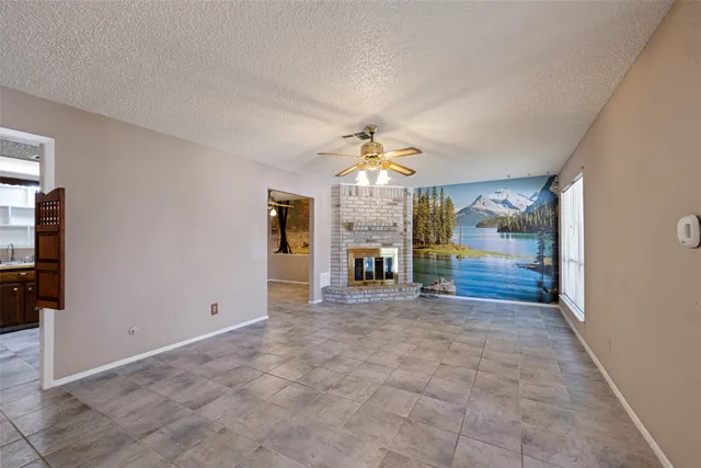 a view of an empty room with a fireplace