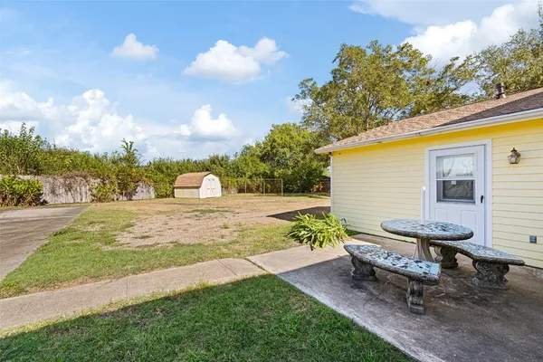 a view of a backyard with sitting area