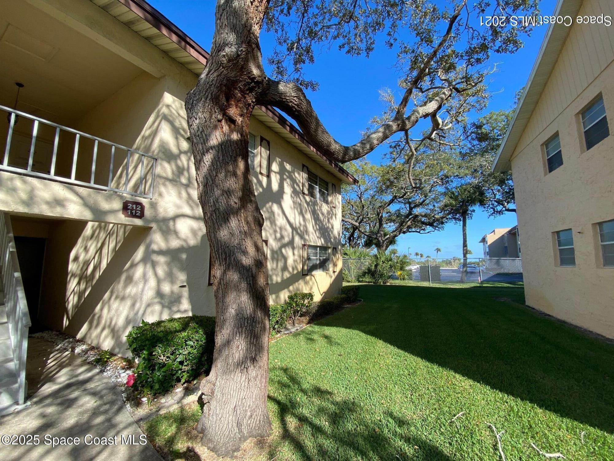 3135 Shady Dell Lane, Unit 112 Melbourne, FL 32935 - Photo 1 of 22 a view of an outdoor space with backyard