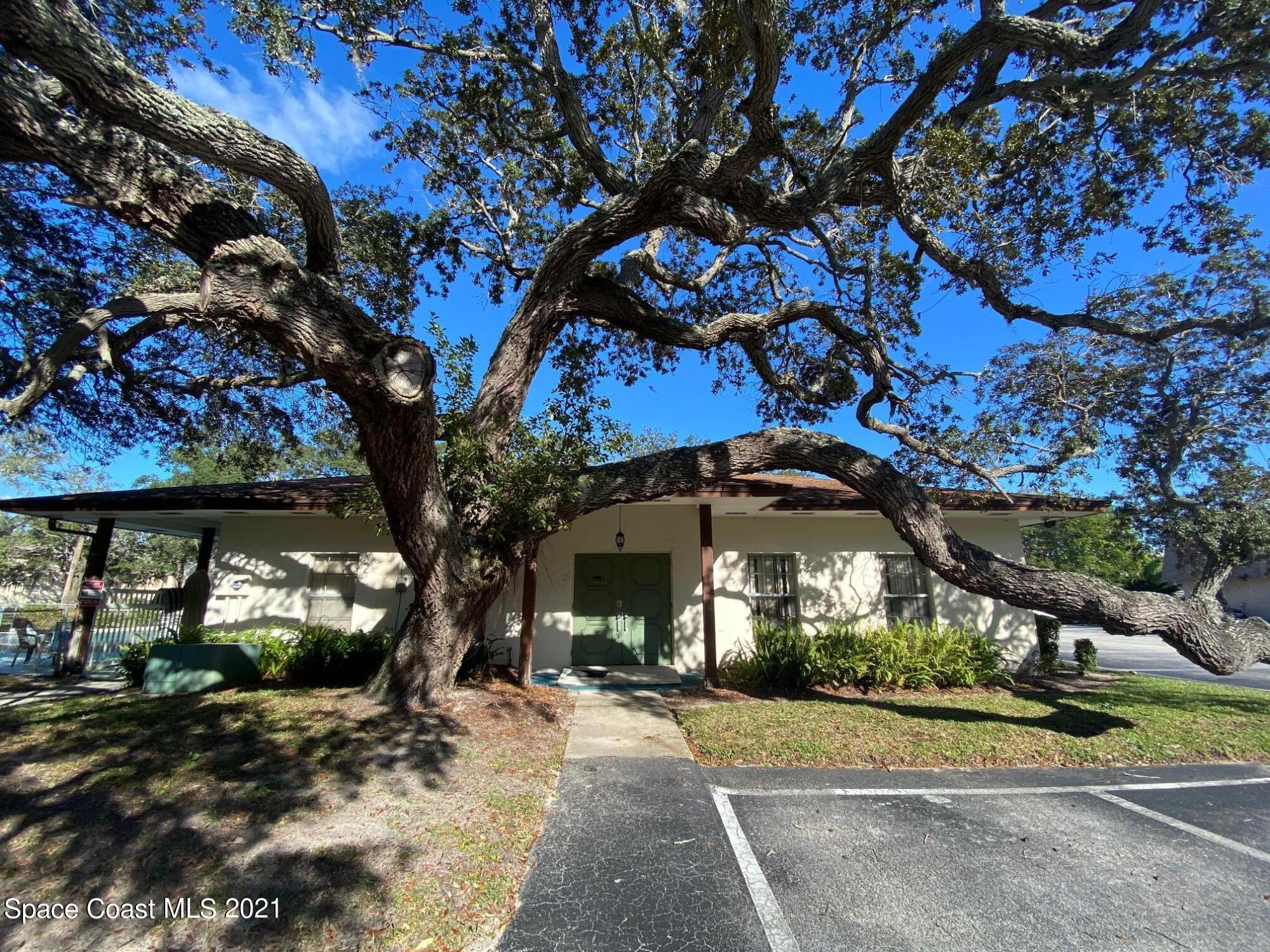 3135 Shady Dell Lane, Unit 112 Melbourne, FL 32935 - Photo 18 of 22 a front view of a house with a yard