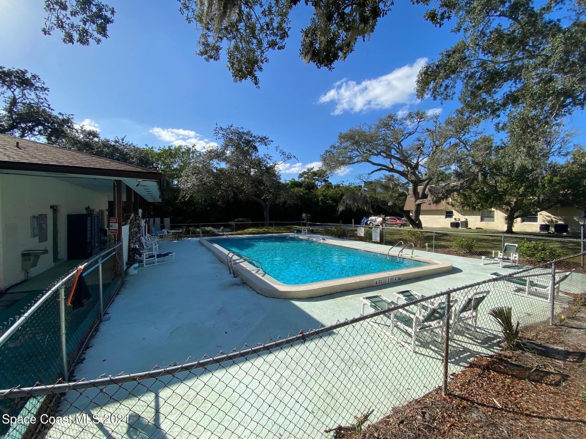 3135 Shady Dell Lane, Unit 112 Melbourne, FL 32935 - Photo 20 of 22 a view of a tennis court