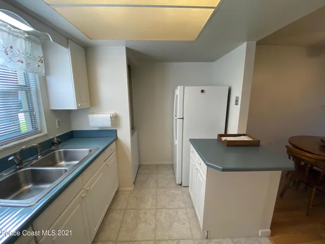 a kitchen with a sink a counter top space and cabinets